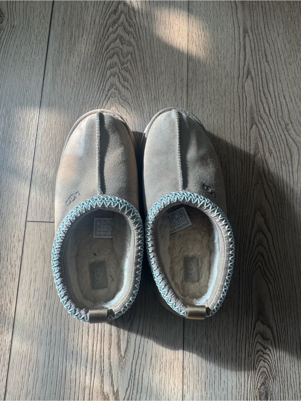 UGG women’s Slip-On Suede Slippers in Light Brown with Blue Trim